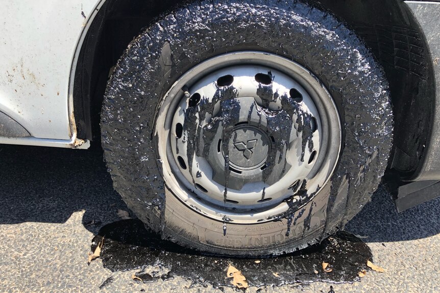A car tyre covered in melted bitumen. 