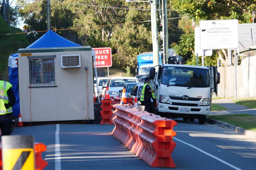 New South Wales – Queensland border checkpoint at Kirra with police beside a small truck amid COVID-19 outbreak