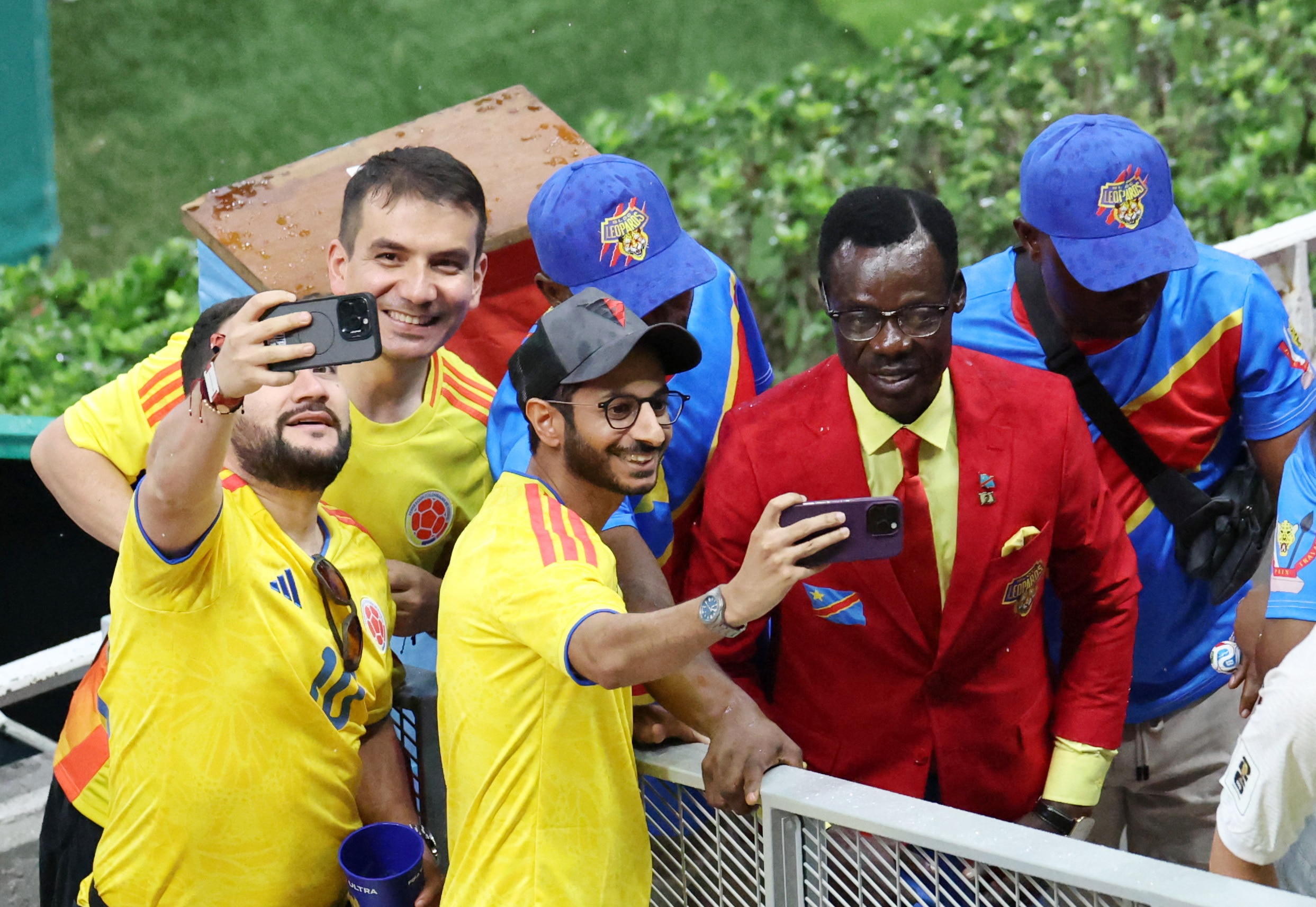 Fans pose for a selfie with DR Congo fan Michel Nkuka Mboladinga