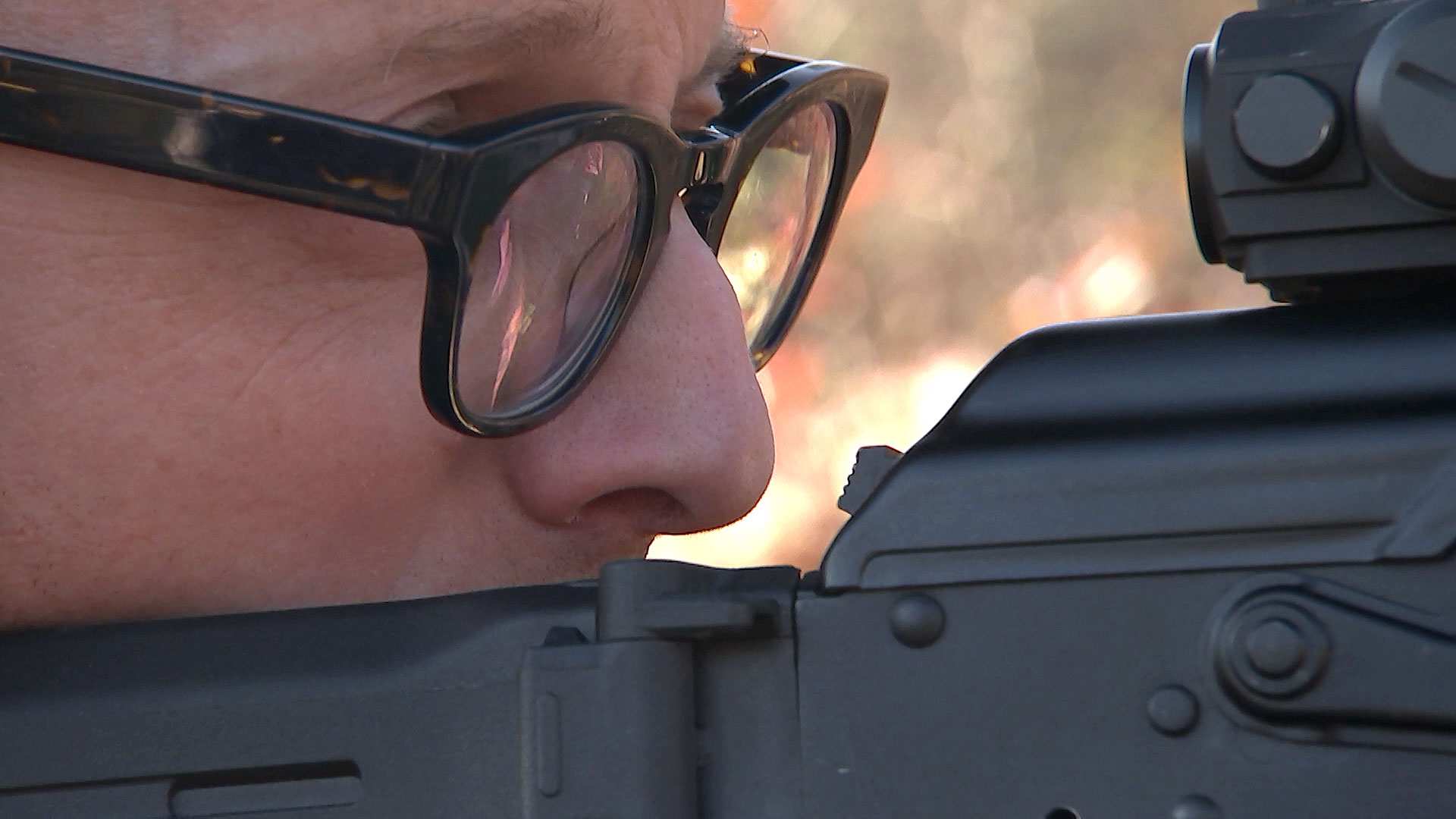 A Redneck Revolt member looks down the sight of his weapon.