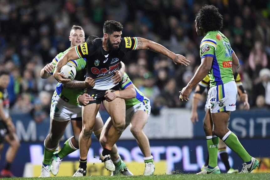 James Tamou of the Panthers is tackled by Junior Paulo and Luke Bateman of the Raiders.