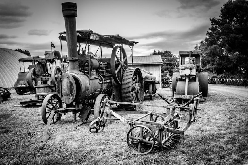 A black and white photo of an old steam engine.