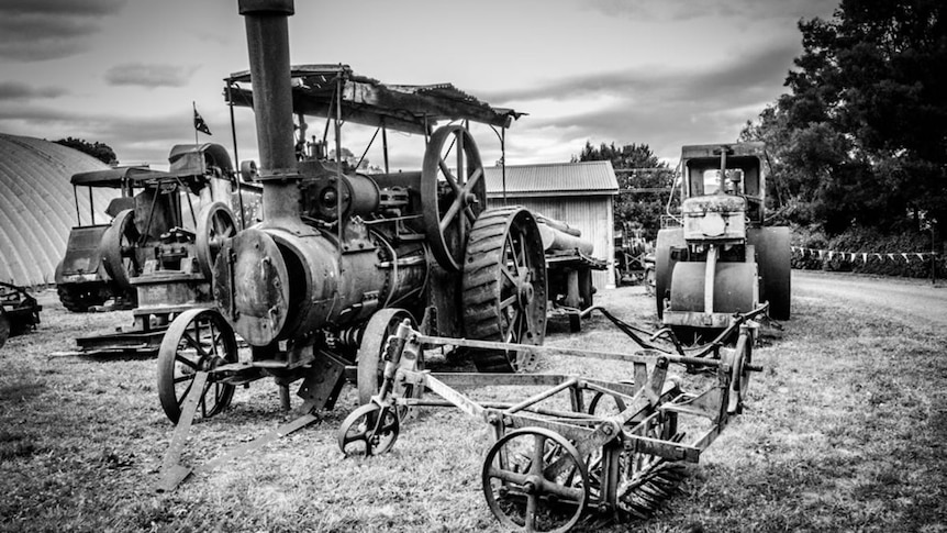 A black and white photo of an old steam engine.