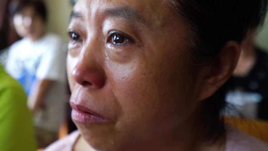 A woman, who has lost money investing in EuroForex, with tears down her face