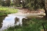 Still from a video showing a flash flood event hitting a Hunter Valley river.