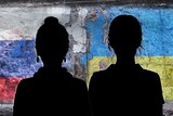 Silhouette of two Russian women standing close with a Russian flag and a Ukrainian flag