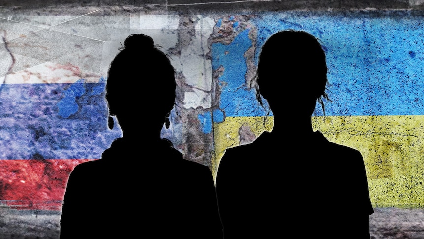 Silhouette of two Russian women standing close with a Russian flag and a Ukrainian flag