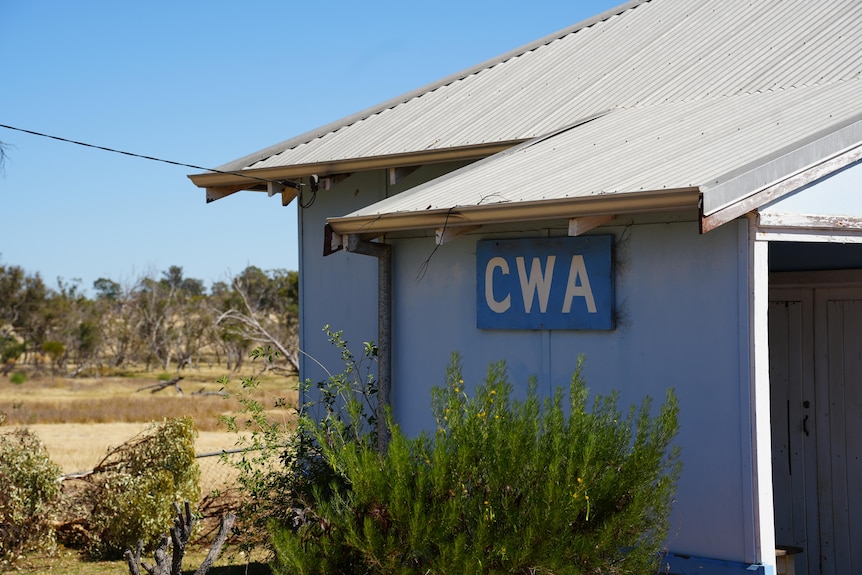 a blue building with a sign reading CWA