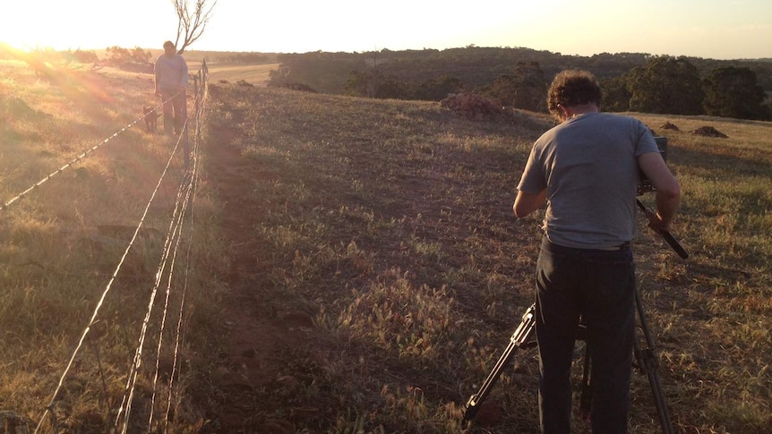 Australian Story cameraman Mark films farmer Stephen Marsh walking along property