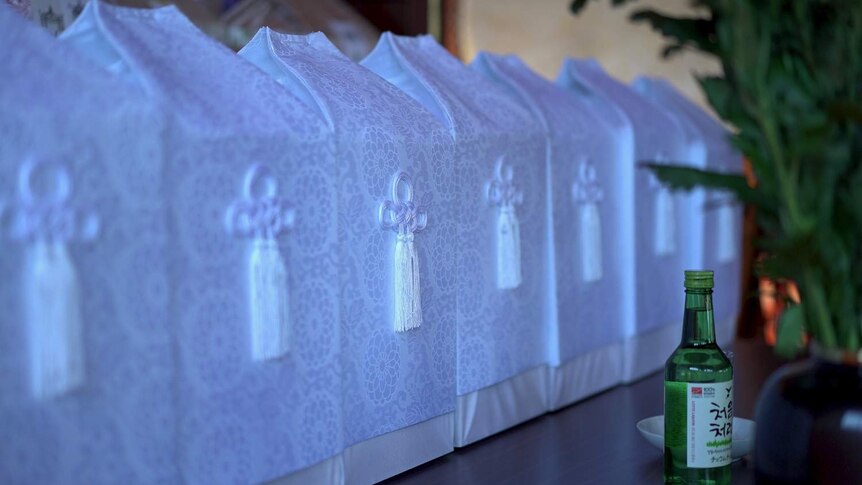 White boxes made of silk in a Buddhist temple in Japan containing cremated remains.
