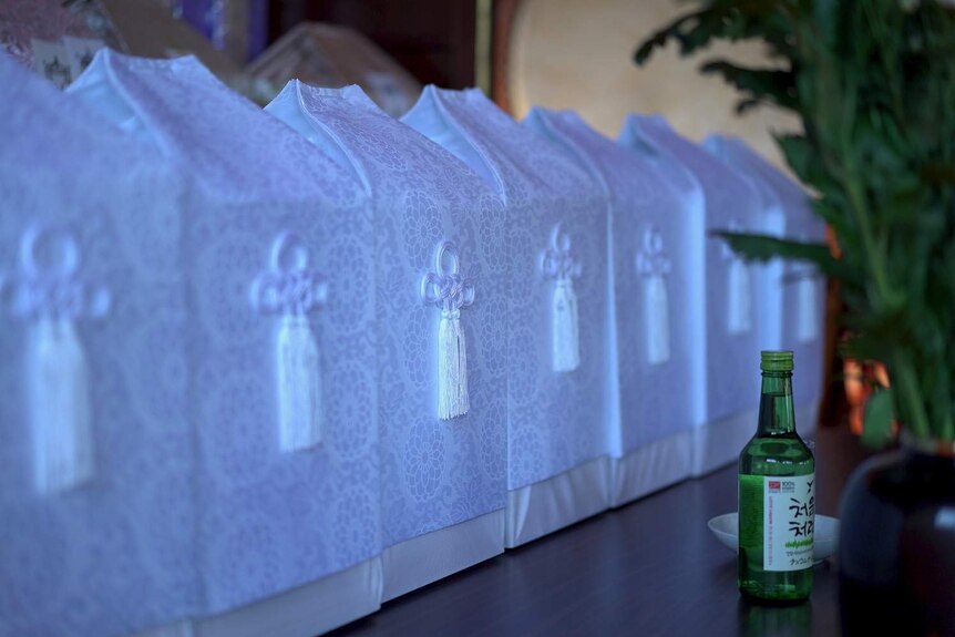 White boxes made of silk in a Buddhist temple in Japan containing cremated remains.