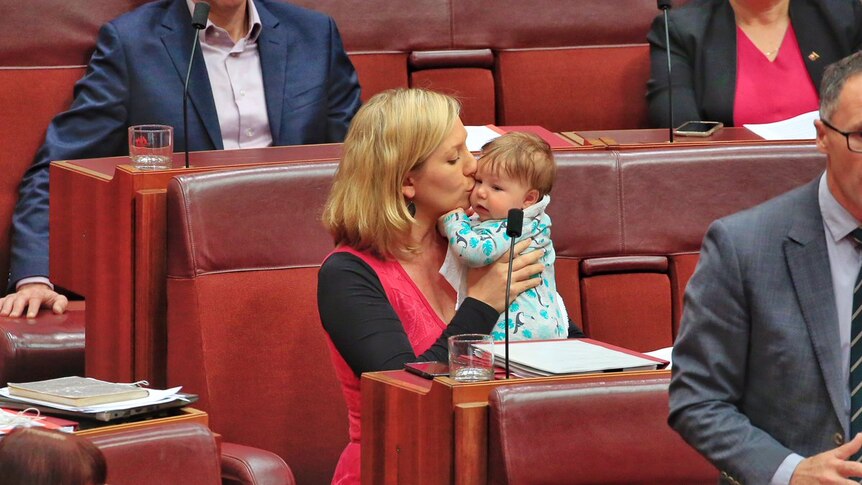 Greens Senator Larissa Waters kisses her baby daughter on the cheek