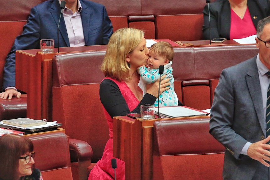 Greens Senator Larissa Waters kisses her baby daughter on the cheek