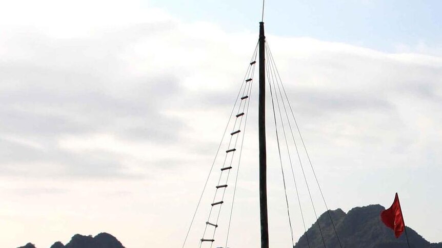 The tourist boat that sunk in Halong Bay sits in the water near Titop island