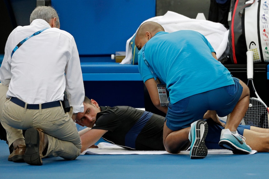 Novak Djokovic gets attention from the physio at the Australian Open
