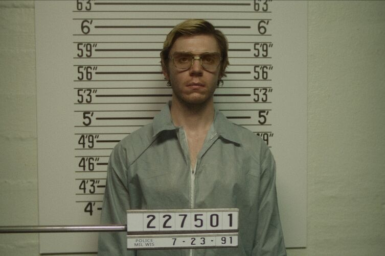 An image of a scene in the Netflix series about Jeffrey Dahmer, showing him having his photo taken in jail