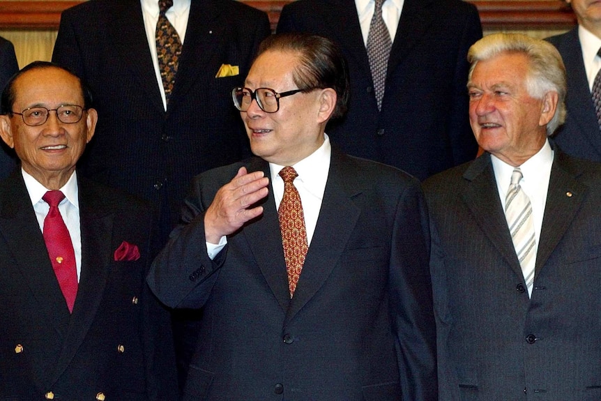Bob Hawk stands side by side with Jiang Zemin and Fidel Ramos.