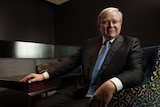 Kevin Rudd sitting behind a desk.