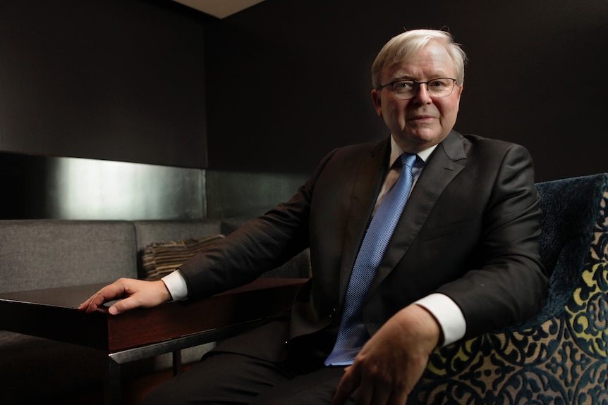 Kevin Rudd sitting behind a desk.