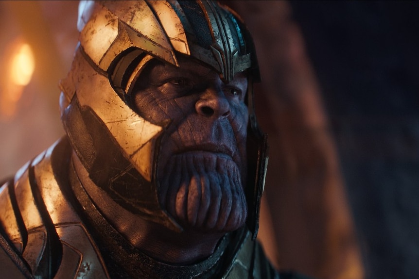 Thanos wearing a gold-coloured helmet.