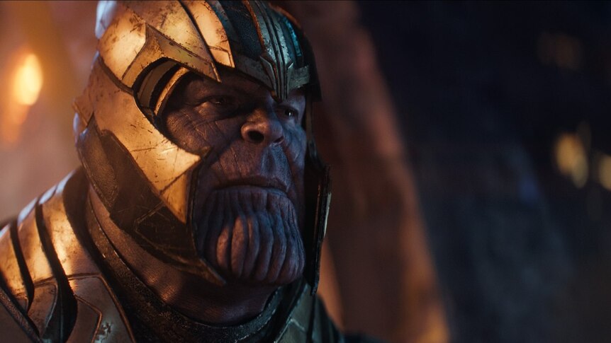 Thanos wearing a gold-coloured helmet.