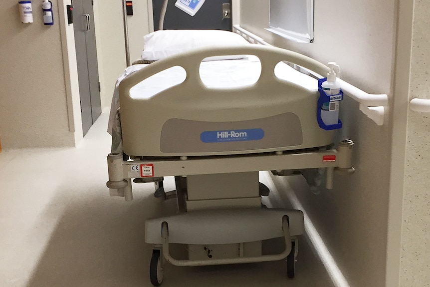 Empty bed in Hobart hospital corridor