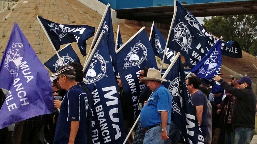 MUA members with flags on the move at Fremantle Port