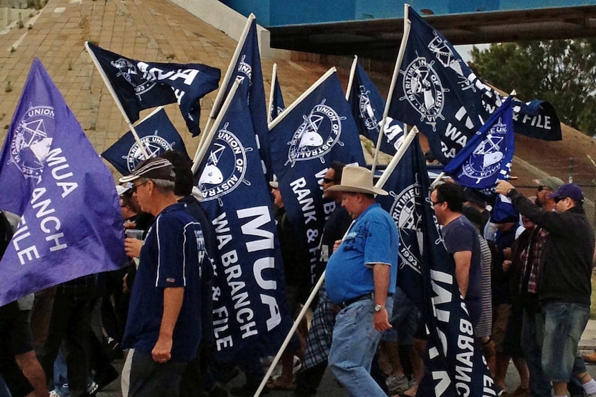 MUA members with flags on the move at Fremantle Port