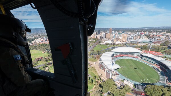 Black Hawk crew member looks over Adelaide Oval.