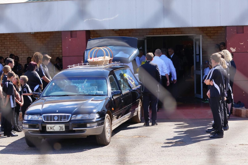 An honour guard of students line the entrance as Elijah Doughty's coffin is carried inside the Maku Stadium in South Kalgoorlie.