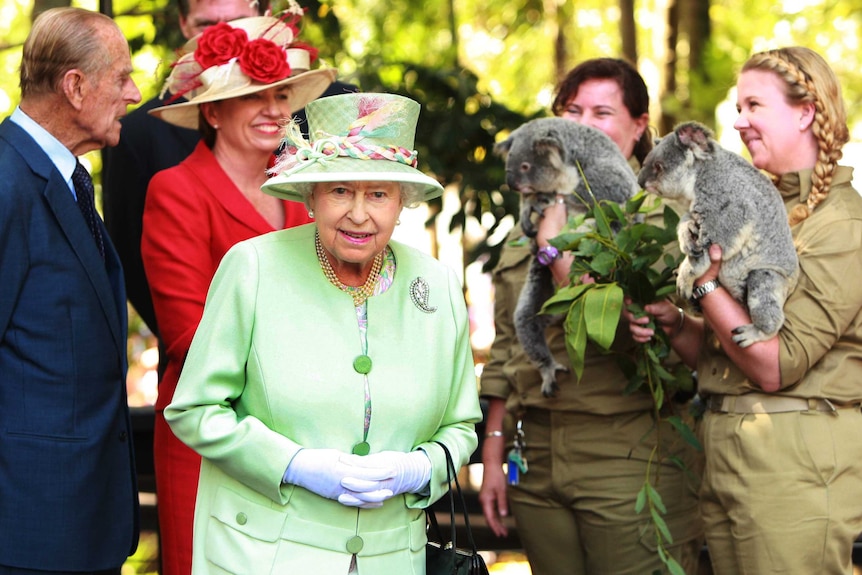 Queen Elizabeth II and the Duke of Edinburgh are greeted by two koalas during a trip to Brisbane.