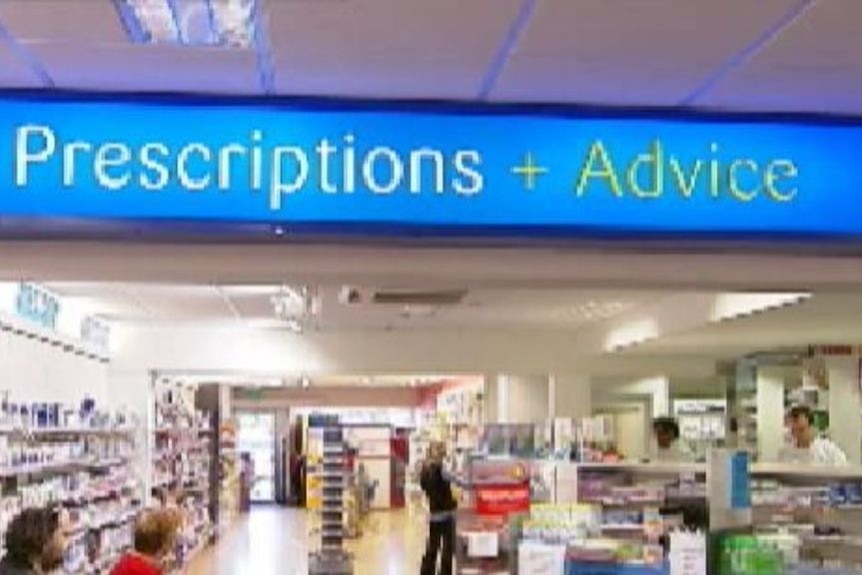 A pharmacy's prescription bay with blue lights and medication behind the counter.
