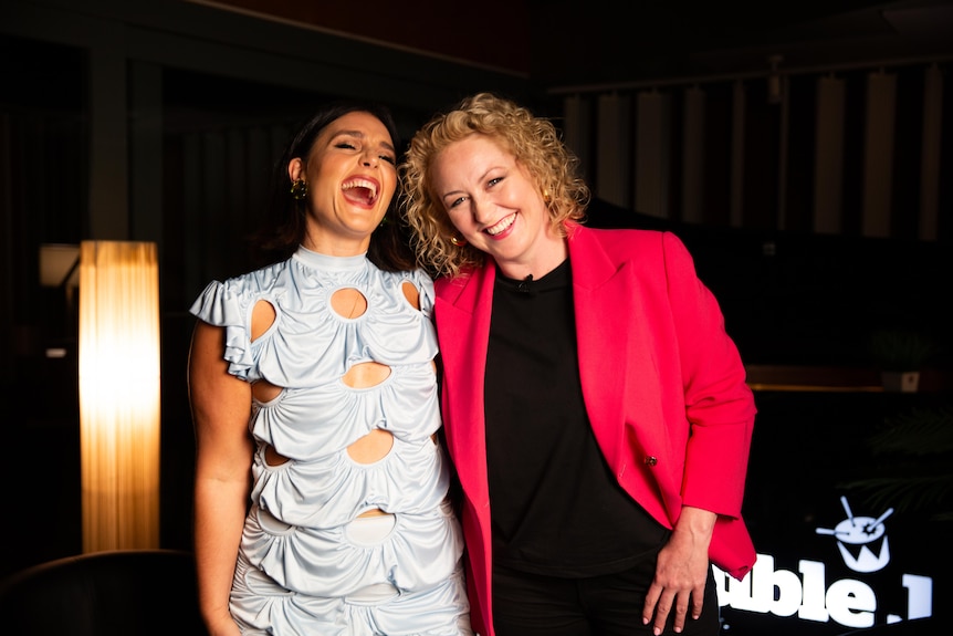 Jessie Ware and Zan Rowe pose for the camera in a sound studio with lamp and Double J logo