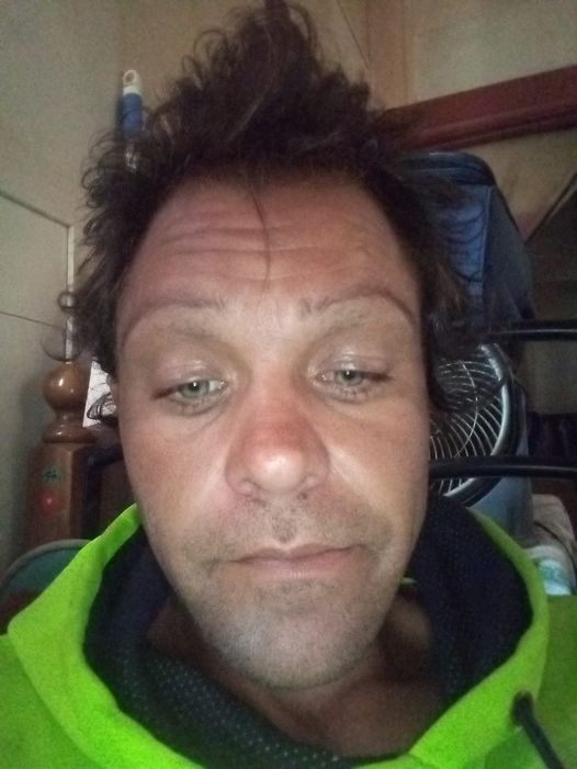 A person wearing a green or yellow jacket