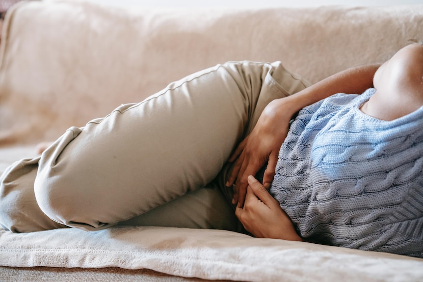 Woman holding her abdomen in pain