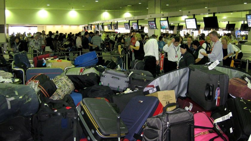 Baggage stacks up in front of the Qantas check-in during a four-hour protest