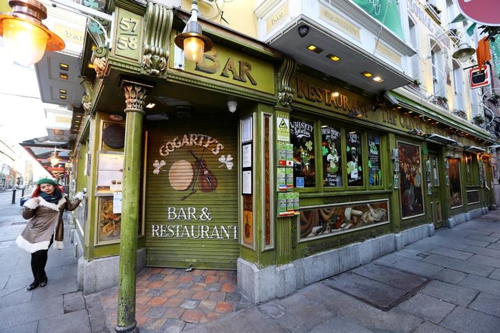 The front of a closed pub bar painted green and yellow named Gogarty's Bara and Restaurant.