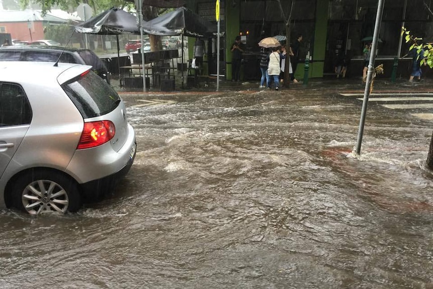 A car drives through flash flooding in Flemington