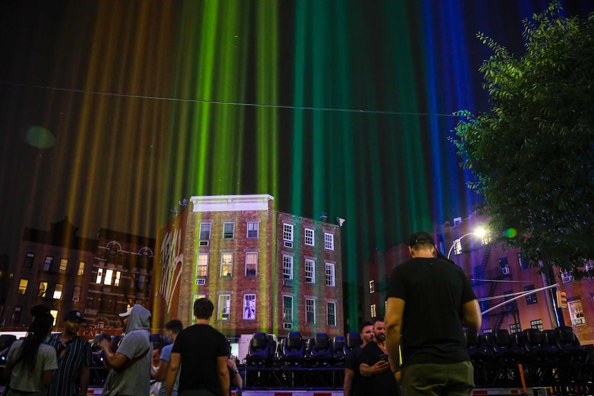 A rainbow light display illuminates the night sky in New York's West Village near The Stonewall Inn.