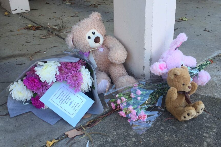 Teddy bears and flowers in front of Queanbeyan unit block