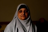 Safaa Morsy, 49, a housewife in Alexandria holds an old photo of her husband, who is on death row.