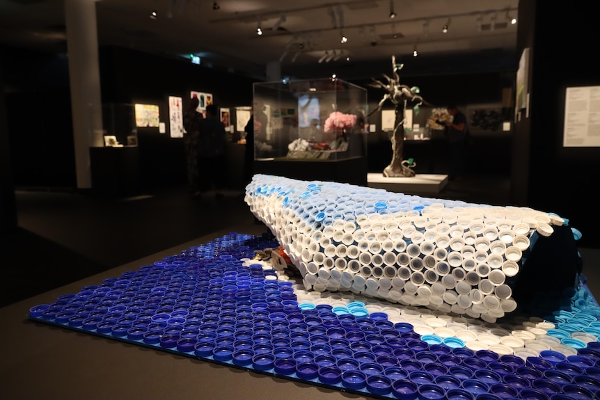 Sculpture of a wave made from bottle caps.