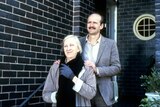 Garry McDonald as Arthur and Ruth Cracknell as Maggie standing in front of a house smiling, hands on shoulders.