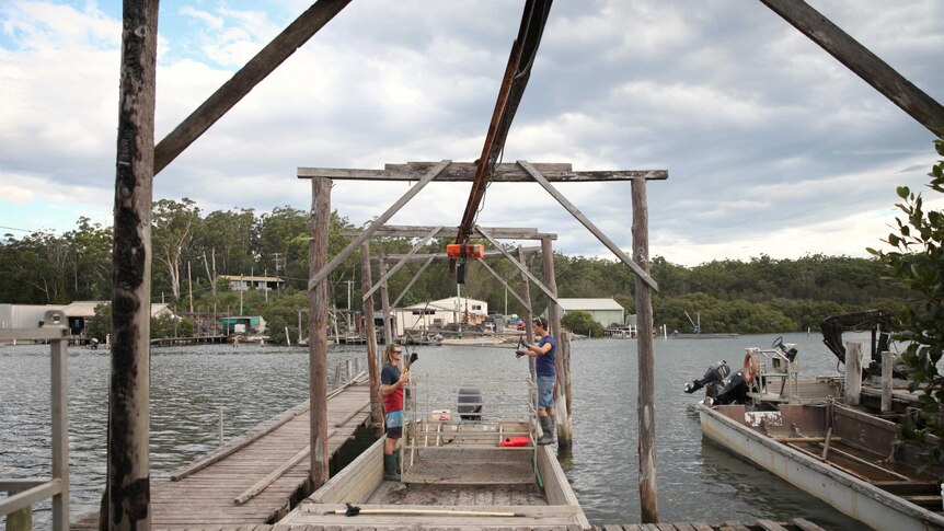 Two oyster workers prepare a boat at Clyde River oyster sheds