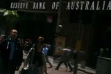 People walk past the reserve bank of Australia in sydney.