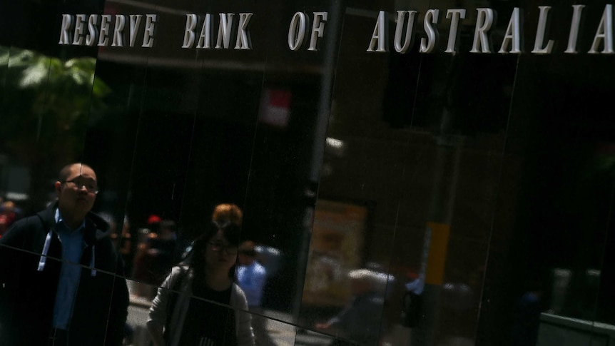 People walk in front of the RBA office.