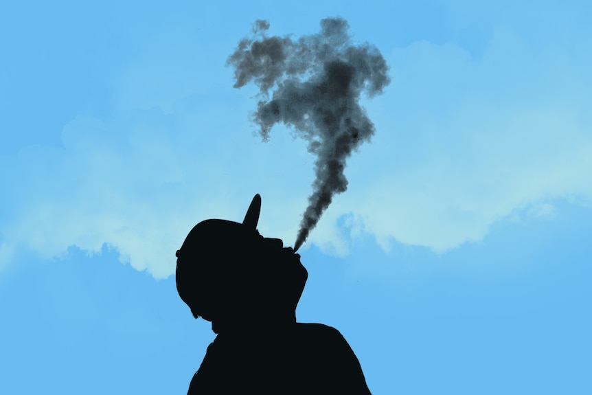 The silhouette of a man vaping