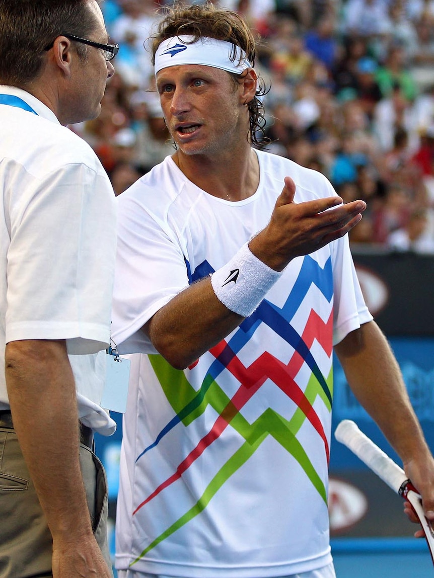 David Nalbandian speaks with Australian Open official Andreas Egli after losing his challenge.