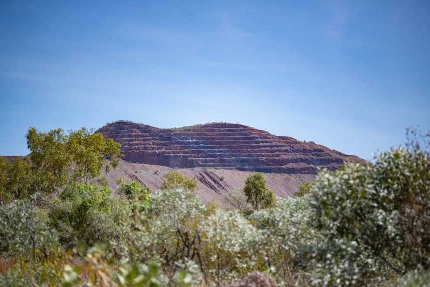 A mine site showing a mountain with layered edges.