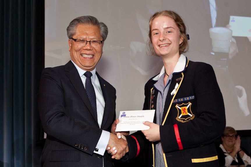 Eliza receiving her prize on stage